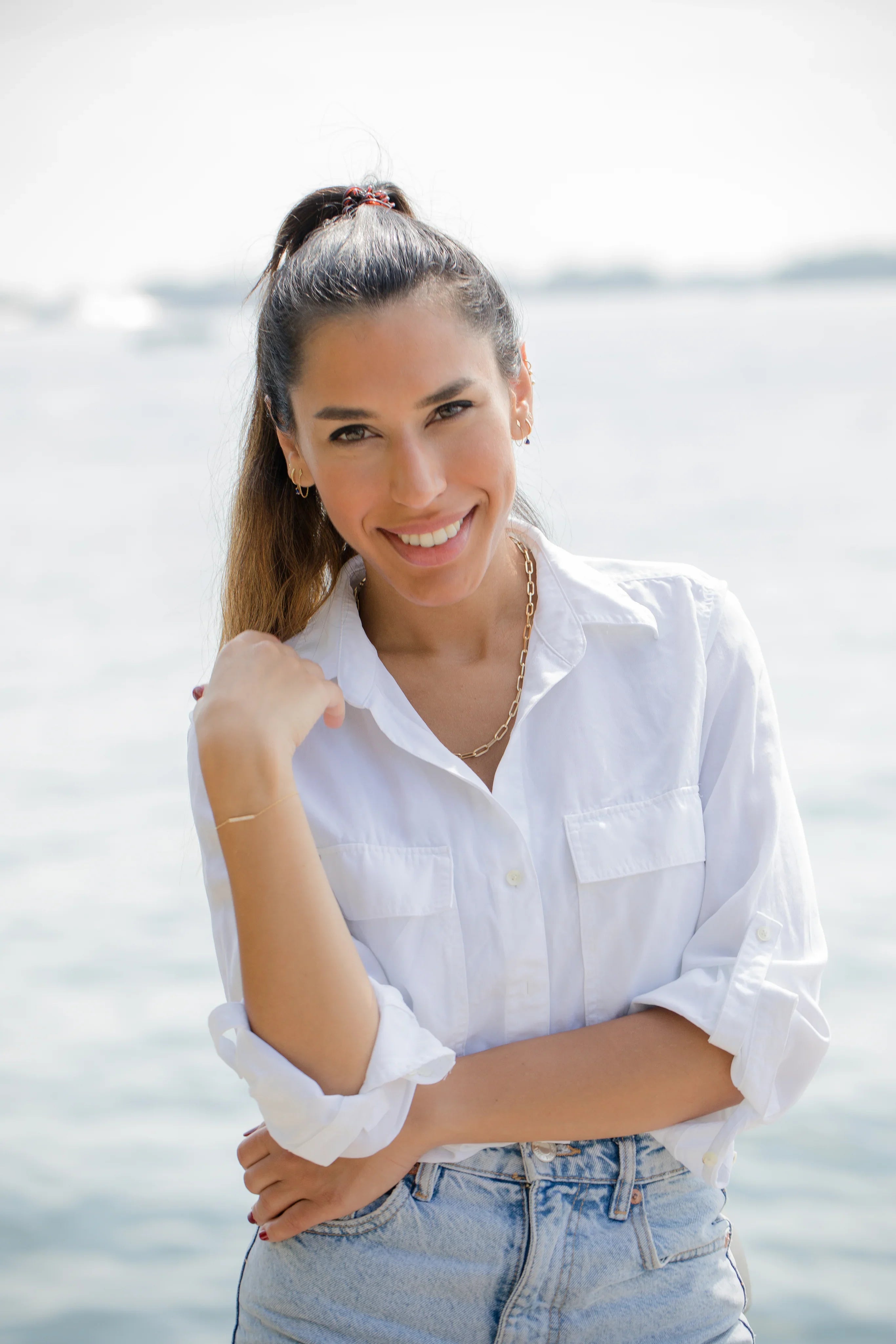 person-in-a-white-shirt-stands-by-the-water - GoHappy